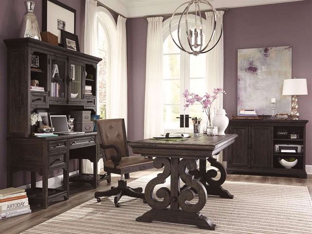 side view of a transitional style home office with matching dark wood ornate furniture