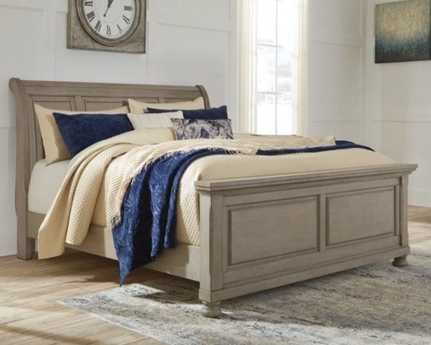 Light-colored sleigh bed frame in a bedroom
