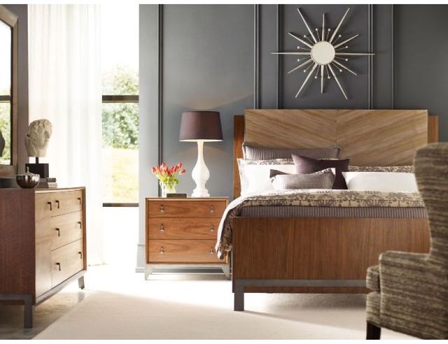 front view of a modern bedroom with a wood bed frame and matching bedroom furniture in a modeern bedroom