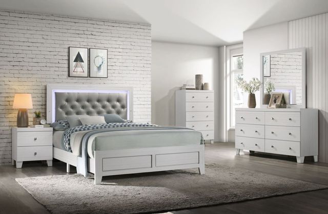 side view of a white bedroom with a white wood and upholstered bed frame 