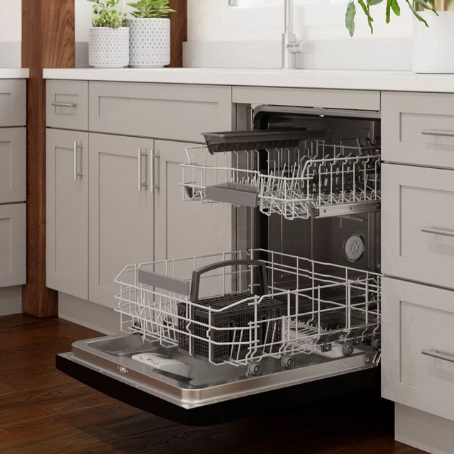 A Bosch dishwasher with front controls is ajar and loaded with clean dishes