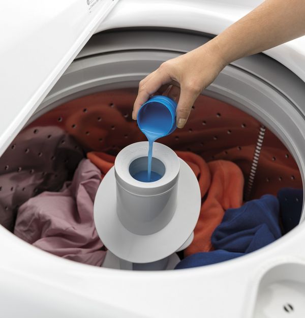 Pouring Laundry Detergent into washer