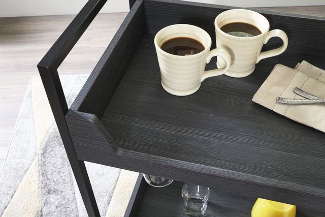 close top view of a black serving cart with two cups of coffee and napkins on top