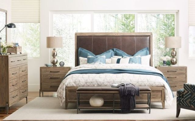 front view of a transitional bedroom with a cal king upholstered bed frame and matching furniture