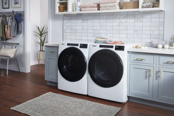 Laundry Room Featuring a Whirlpool 5.0 Cu. Ft. White Front Load Washer