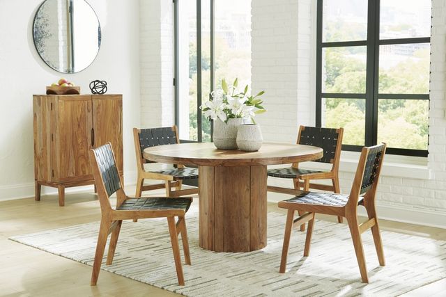 front view of a modern rustic dining room with a wooden round pedestal dining table and matching sideboard