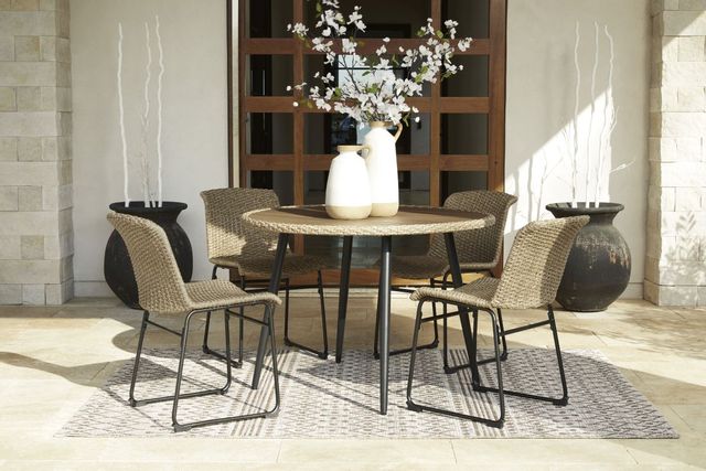 front view of a circle outdoor dining table with four chairs around on an outdoor patio 