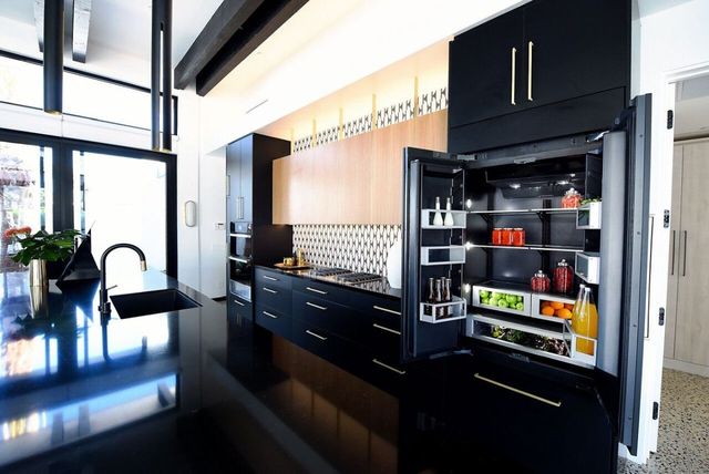 black counter depth refrigerator in a modern kitchen