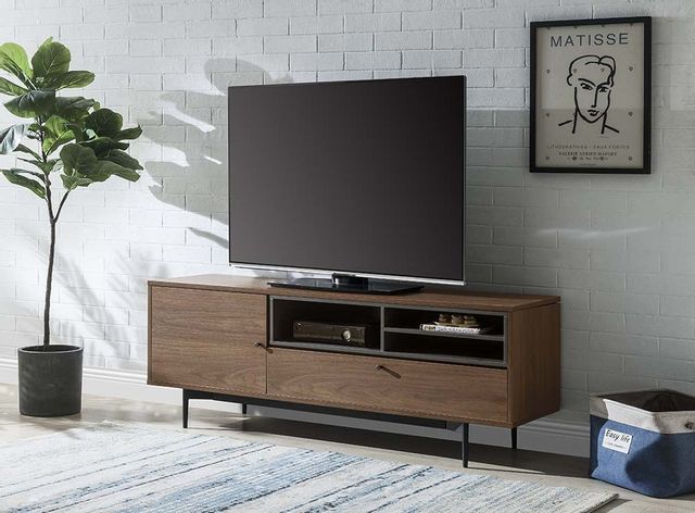 front view of a mid-century modern wood tv stand with a large tv on top