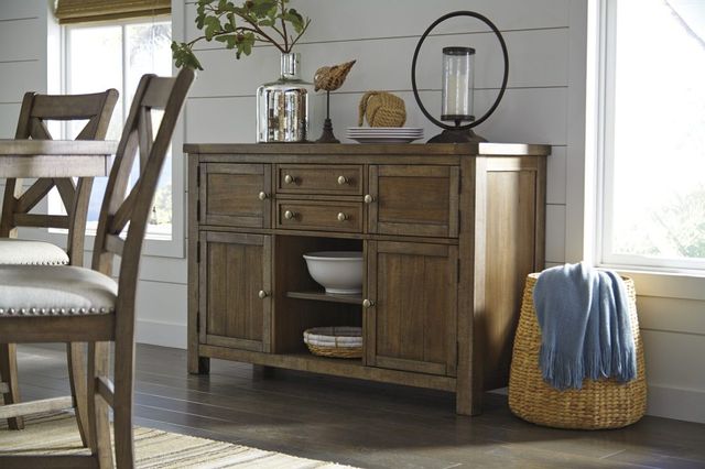 view of a dark wood rustic sideboard in a modern rustic dining room with accents on top