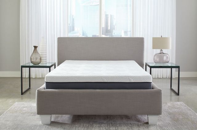 queen-hybrid-pros-cons front view of a queen hybrid mattress in an all white room