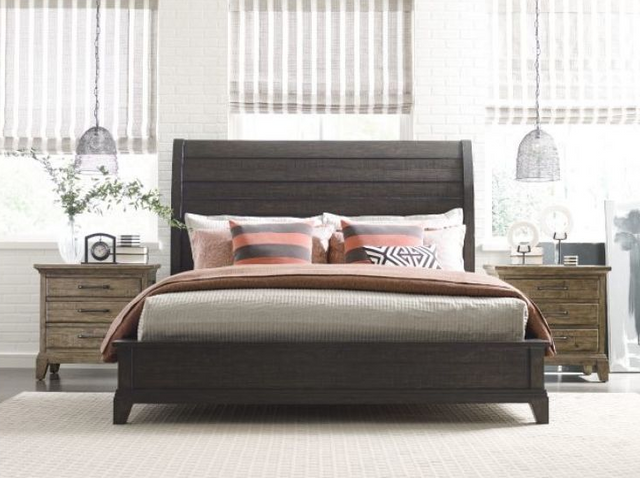 front view of a modern bedroom with a dark wood bed frame, white walls, and pink and gray accents