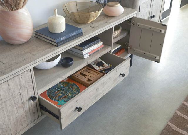 close view of a modern entertainment center with accents and decor and games stored in a pulled out drawer