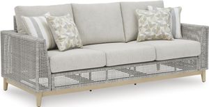 front left view of the Signature Design by Ashley® Seton Creek Gray Outdoor Sofa with Cushion, a grey transparent wicker outdoor sofa with light grey cushions