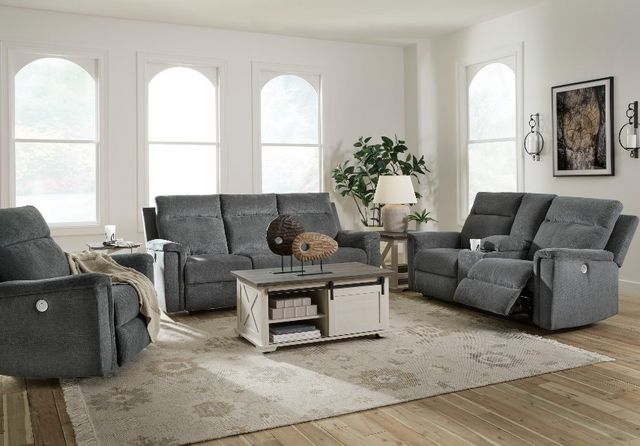 front view of a modern living room with a light blue fabric sofa, loveseat, and chair