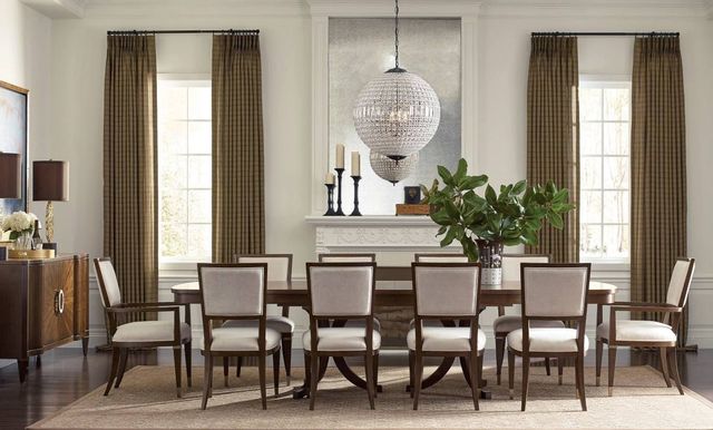front view of a modern dining room with a large double pedestable table and 10 chairs around it