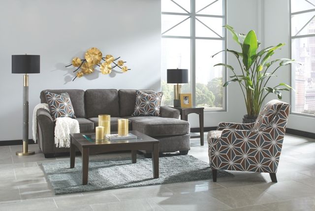front view of a transitional living room with a grey sofa and matching patterned accent chair