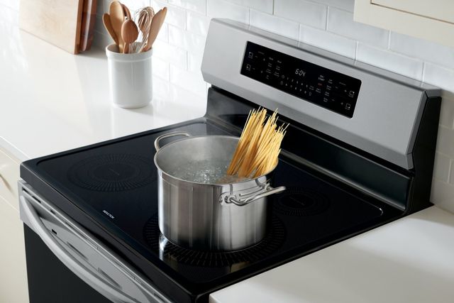 view of a frigidaire induction range with a pot of pasta boiling on top
