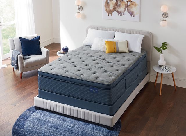 front view of a modern minimal bedroom with a grey mattress, chair, and headboard