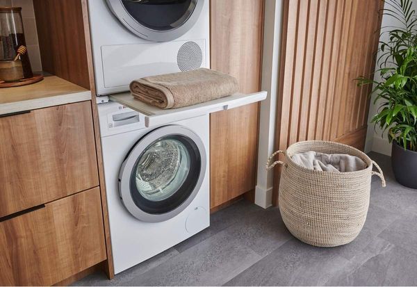 Laundry Room Featuring Bosch 500 Series 4.0 Cu. Ft. White Front Load Electric Dryer