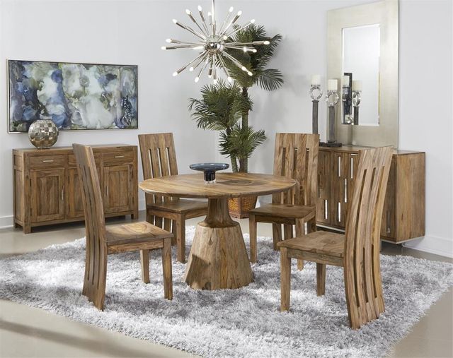 round wood pedestal dining table and matching chairs in a bright dining nook