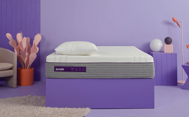 Purple hybrid mattress in a purple bedroom