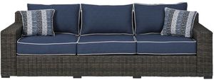 front view of the Signature Design by Ashley® Grasson Lane Brown/Blue Sofa with Cushion, a dark brown resin wicker sofa with navy blue chushions