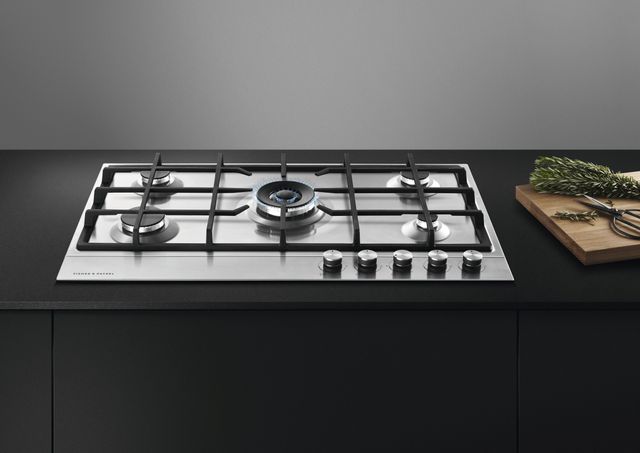 Fisher Paykel gas cooktop with an adjacent cutting board