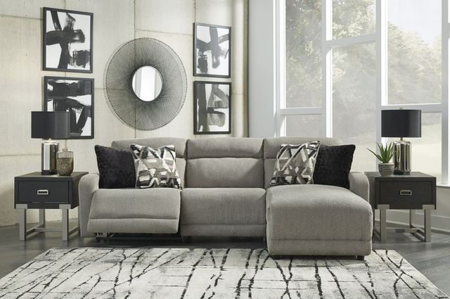 front view of a contemporary living room with a reclining chaise sofa, two black end tables, and black and white decor throughout