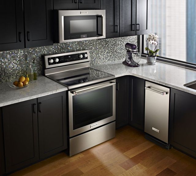 new appliances installed into a kitchen with black cabinets