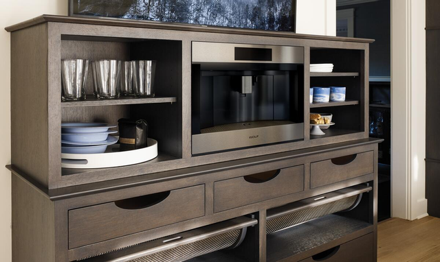 view of a brown coffee bar with a built in coffee maker