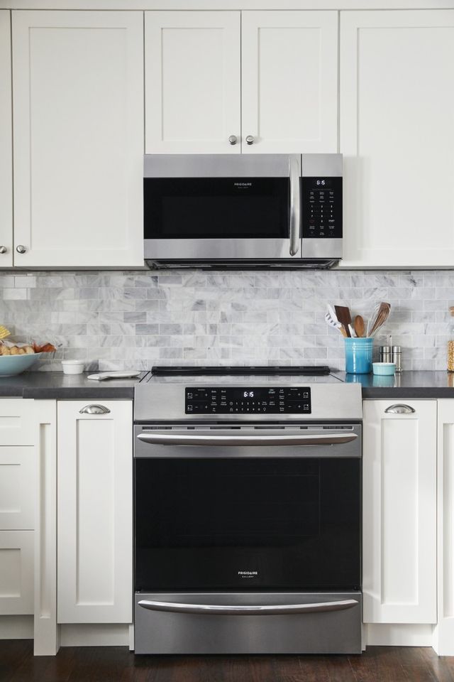 Stainless steel Frigidaire Gallery induction range in kitchen with white cabinets