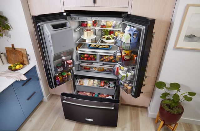 top view of an opened and fully-stocked kitchenaid side-by-side refrigerator in a modern kitchen