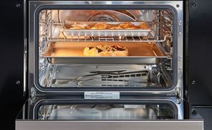 The inside of a Wolf steam oven is shown as it cooks pastries