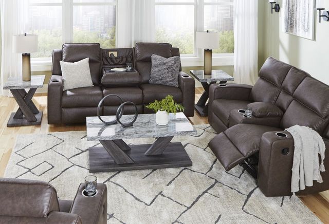 front view of a modern living room with two brown leather loveseats and throw pillows