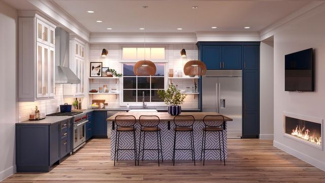 front view of a modern kitchen with a large 48" refrigerator built into blue cabinetry