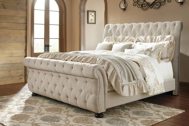 front view of a traditional bedroom with a cream upholstered sleigh bed