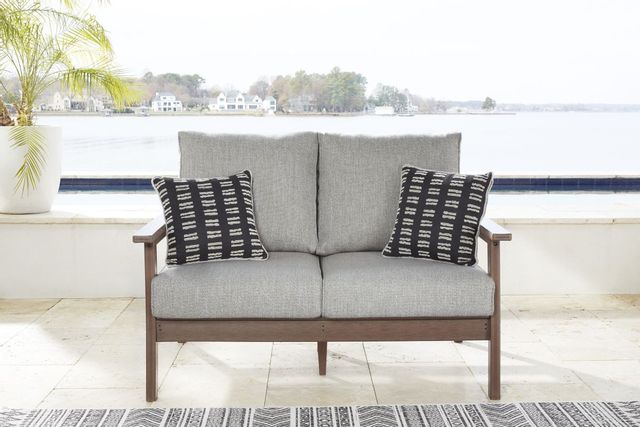 front view of an outdoor loveseat on a modern patio in front of a bay