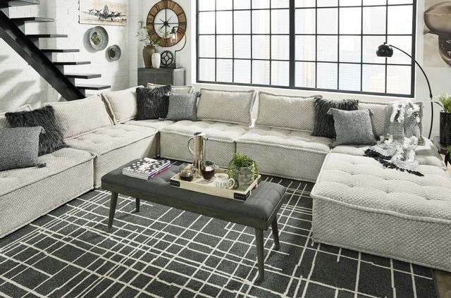 front view of a modern contemporary living room with a beige modular sectional sofa
