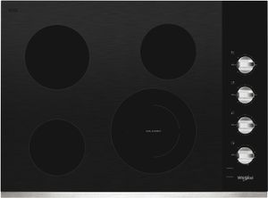 Black Whirlpool electric cooktop with silver dials