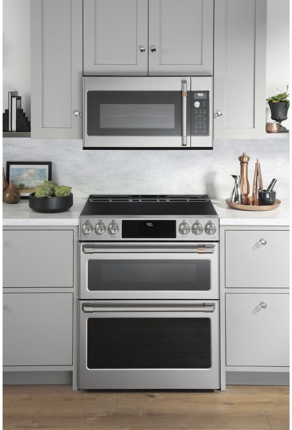 An over the range microwave and double oven range installed in a lovely, modern kitchen