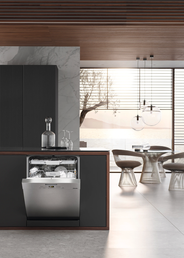 Miele dishwasher slightly ajar in modern minimalist home