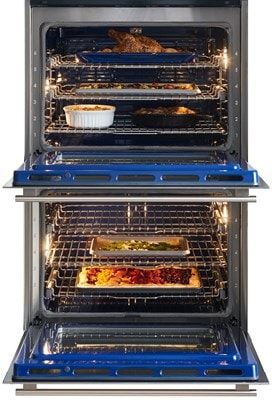 Wolf double oven with open doors and food being cooked inside