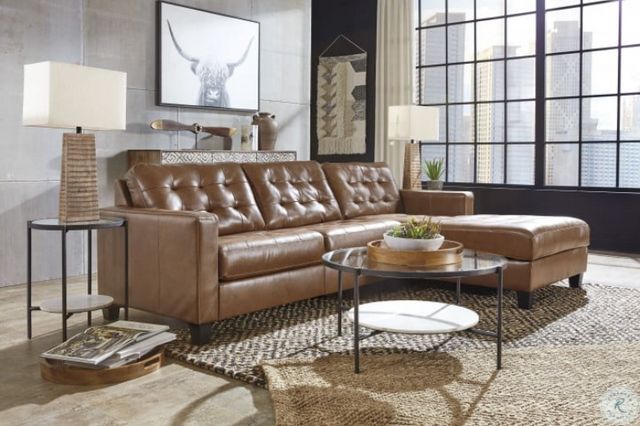 front view of a rustic living room with a leather couch with chaise