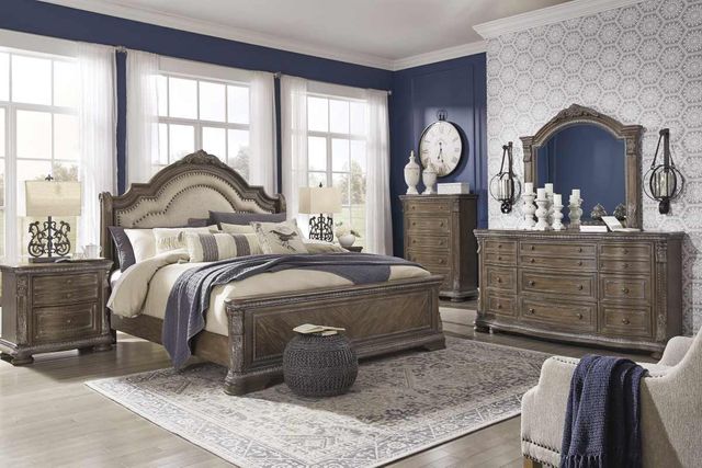 front view of a traditional bedroom with a matching bedroom set and a dresser with mirror