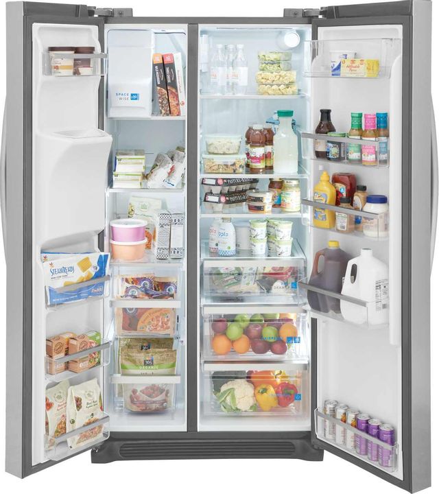 Frigidaire side by side refrigerator open with food stocked in it
