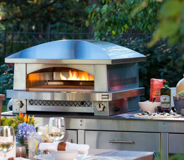 front view of an outdoor cooking area with stainless steel counters and a stainless steel outdoor pizza oven