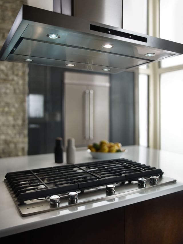 An image of a gas cooktop with an island range hood
