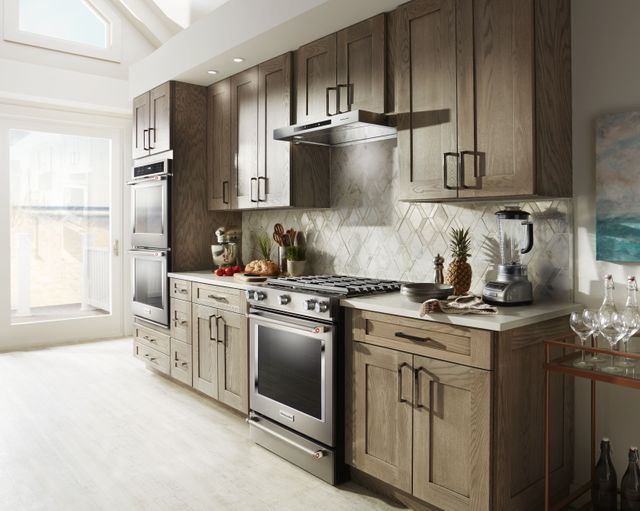 KitchenAid gas range in a kitchen outfitted with stainless steel KitchenAid appliances