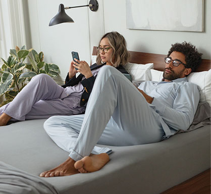 couple in bed looking at media